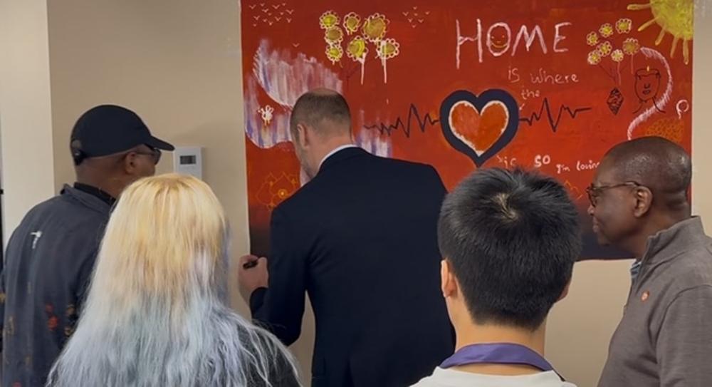 Guests beside the painted Home mural
